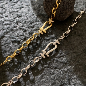 Luxe horseshoe buckle bracelet in gold and silver finish with sparkling micro-pave crystals