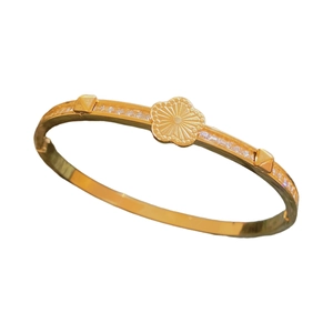 Elegant gold titanium steel clover bangle with radiating floral pattern and zircon stones