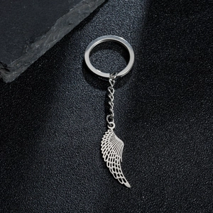 Polished stainless steel keychain featuring a detailed hollow angel wing feather pendant