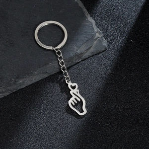 Close-up of stainless steel finger heart pendant keychain with a silver metallic finish