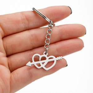 Close-up of polished stainless steel keychain featuring a double heart with arrow design