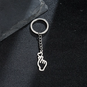 Detail of silver stainless steel keychain featuring a heart gesture hand pendant design