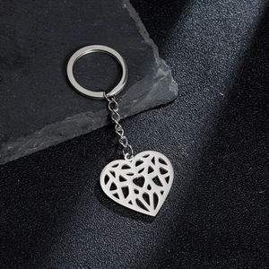 Detailed macro shot of silver hollow heart keychain made of polished stainless steel metal