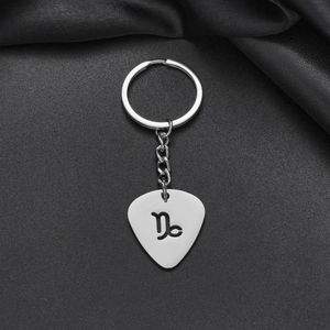 Detailed macro of silver stainless steel keychain with hollowed-out Capricorn zodiac sign