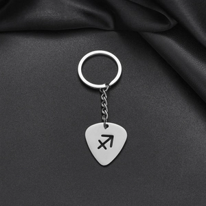 Detailed close-up of a silver stainless steel guitar pick keychain with Sagittarius cutout