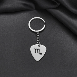 Detailed macro of a polished Scorpio zodiac sign on a stainless steel keychain