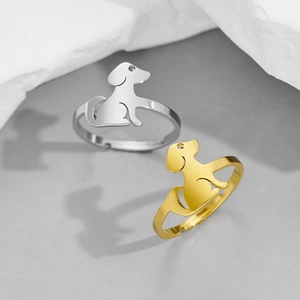 Polished stainless steel puppy rings in gold and silver finish on stone display