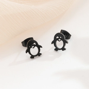Close-up of cute black stainless steel penguin earrings with hollow belly design