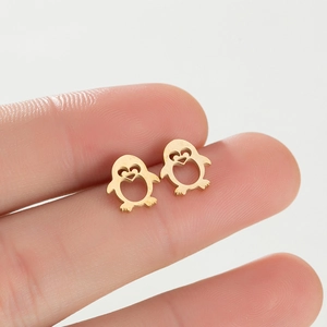 Close-up of cute penguin stud earrings in gold-toned stainless steel with hollow design