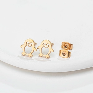 Macro shot of gold penguin stud earrings with hollow design and butterfly backs