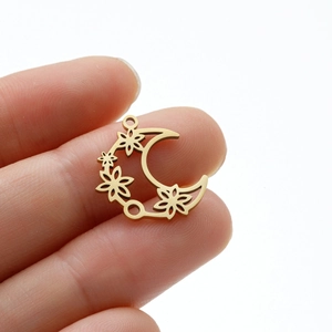 Macro detail of a golden crescent moon flower pendant with double rings for DIY jewelry