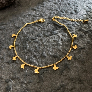 Elegant 18K gold plated titanium steel bracelet with butterfly charms on dark stone
