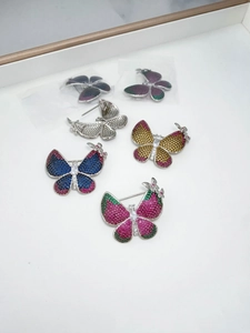 Detailed view of the back pin closure and pave zircon setting on butterfly brooches