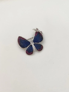 Detailed macro view of the two-tone butterfly brooch with micro-pave zirconia crystals