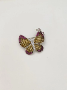 Macro shot of butterfly brooch featuring yellow and purple pavé zircon crystals