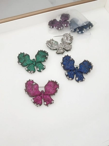 Detail of butterfly brooches showing sparkling zircons and a secure pin fastening on back