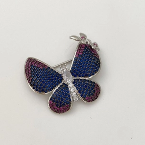 Elegant butterfly brooch with blue and purple cubic zirconia in silver metal setting