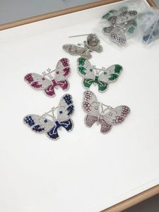 Macro shot of colorful butterfly brooches featuring micro-set zircon and safe pin structure