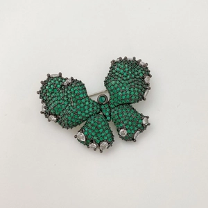 Sparkling butterfly brooch pin with green cubic zirconia in a silver and black setting