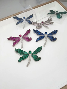 Detail of dragonfly brooches featuring vibrant micro-pave gemstone settings in multiple colors