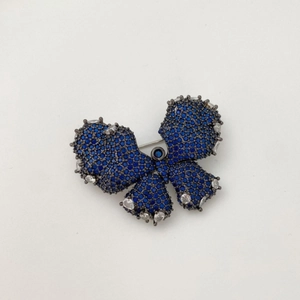 Elegant butterfly brooch in gunmetal finish with sparkling dark blue zircons and clear gems