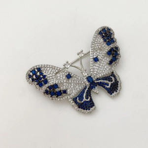 Elegant silver butterfly brooch with sparkling blue and white rhinestones for women