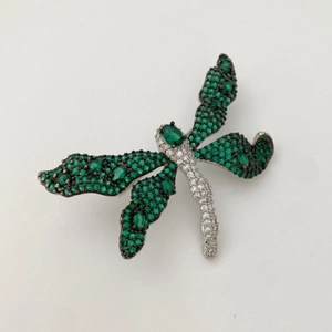 Elegant dragonfly brooch with green emerald gems and white crystal pave setting