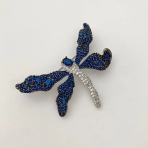 Elegant dragonfly brooch with blue sparkling gemstones and silver-tone metal details