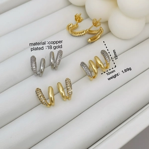 Asymmetric micro-set zircon geometric earrings in 18K gold plated copper on a display tray