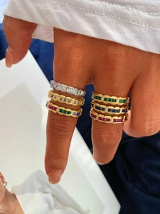 Detail of stacked chain-link rings with colorful square zircon stones in gold and silver