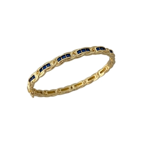 Luxurious gold braided cuff bracelet featuring square blue zircon stones and side clasp