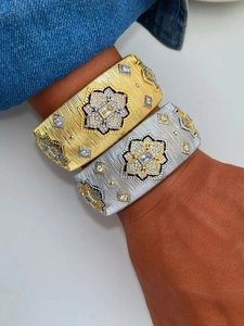 Detailed view of wide brushed texture bangle featuring zircon stones in gold and silver finish