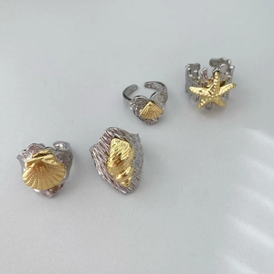 Detailed close-up of marine-themed ocean rings set with starfish and seashell charms