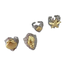 Marine style 18k gold two-tone open rings featuring starfish and seashell designs