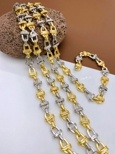 Detailed macro view of two-tone gold and silver metal chain links with high polish finish