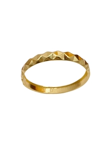 Detailed view of golden wave bracelet with geometric faceted relief and mirror polish finish