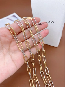 Detail view of gold and silver dual-tone paperclip chain links with 7x17mm dimensions