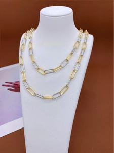 Detail shot of two-tone gold and silver paperclip chain necklace on neck bust