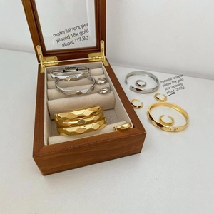 Polished 18K gold plated copper wave bracelet and adjustable ring set in a wooden box
