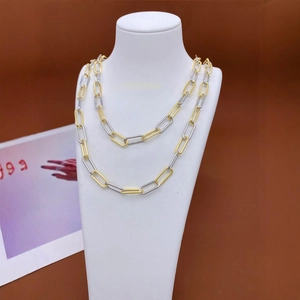 Modern dual-layer gold and silver mixed metal chain necklace on a white neck bust
