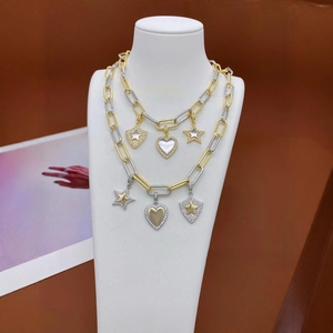 Two-tone gold and silver chain necklace set with heart and star charms on a neck bust