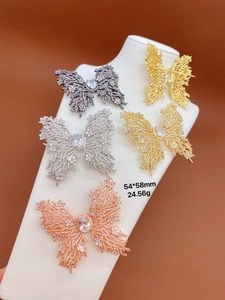 Detail view of five crystal butterfly brooches showing 54x58mm size and 24.56g weight
