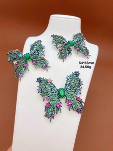 Detailed close-up of a sparkling green zircon butterfly brooch with colorful micro-inlays