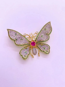 Macro view showing detailed cubic zirconia micro-inlay on gold butterfly brooch