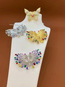 Detailed view showing the metal pin structure and vibrant micro-pave zircon butterfly brooch