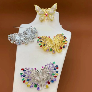 Micro-inlaid zircon butterfly brooches with colorful gemstones on a display stand