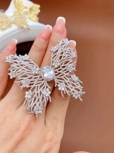 Dramatic silver butterfly ring with intricate filigree wings and oval clear zircon