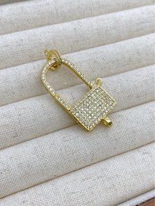 Detailed macro view of 18K gold-plated padlock charm with micro-paved cubic zirconia stones