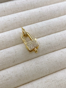 Macro detail of 18K gold plated padlock charm with pave-set zircon for DIY jewelry