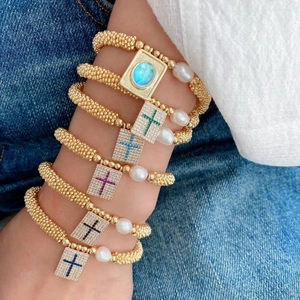Golden beaded stretch bracelet set with pearls and gemstone cross rectangle pendants